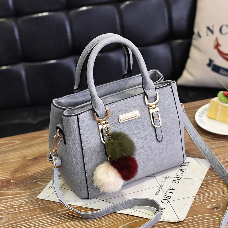 Elegant Pink Handbag with Pom Pom Charm