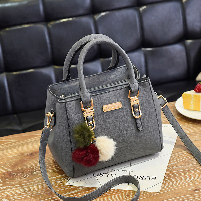 Elegant Pink Handbag with Pom Pom Charm